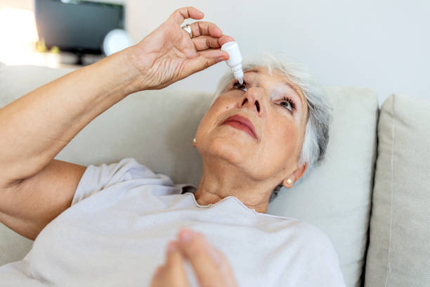 istock Cropped shot of a elderly female person using eye drops. 1337791073