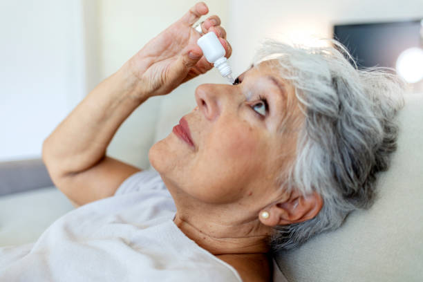 istock Cropped shot of a elderly female person using eye drops. 1337791114