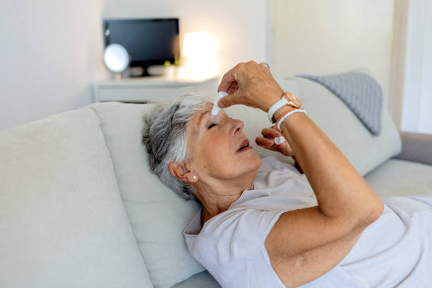 istock Woman applying artificial tears, antibiotics, antihistamine. 1337792020