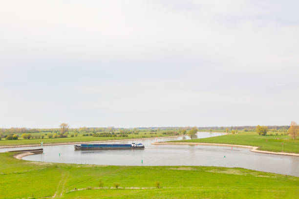 Cargo inland ship on the river IJssel near Zutphen in Gelderland Dutch cargo inland ship on the river IJssel near Zutphen in Gelderland, The Netherlands ijssel photos stock pictures, royalty-free photos & images