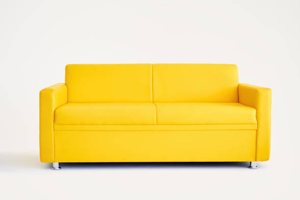 Comfortable yellow sofa on white background stock photo