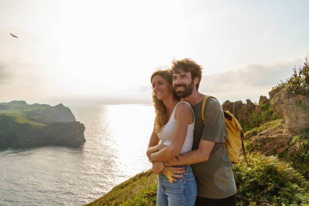istock Couple in love hiking in a cliff. 1337794219