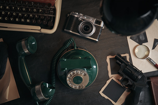 Flat lay composition with vintage detective items on wooden table