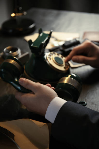 istock Detective dialing number on vintage telephone at table, closeup 1337795478
