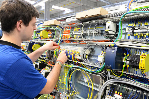 istock young operator assembles machine in a modern high tech factory - production of switch cabinets for industrial plant 1337795705