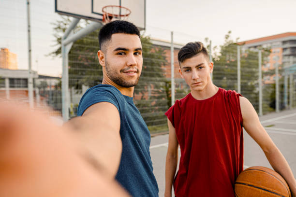 istock Two men posing on a basketball court 1337797279