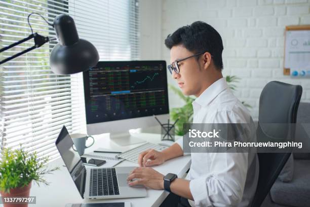 Concentrated Young Asian Modern Man In Formalwear Working Using Computers While Sitting In The Office Stock Photo - Download Image Now