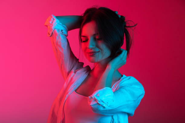 istock Cropped portrait of young beautiful lady posing on gradient pink red studio background 1337798090
