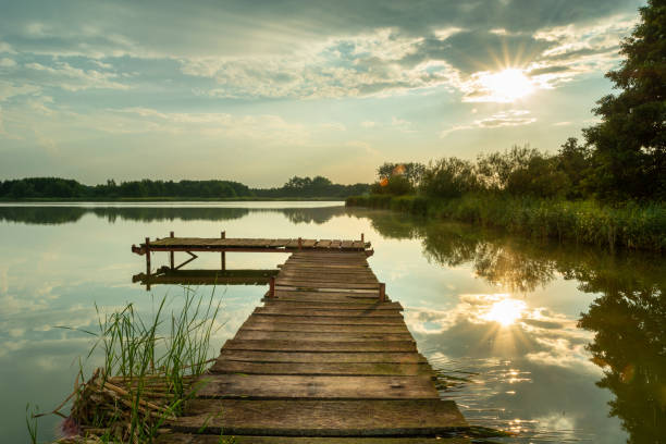 istock Sunlight reflecting on the lake with a pier 1337798215