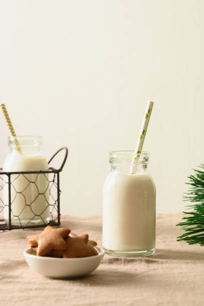 homemade christmas cookies as stars and milk in bottle for santa claus. - milk milk bottle drinking straw cookie imagens e fotografias de stock