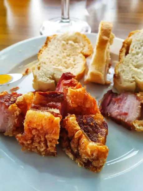 Photo of torrezno with bread, a typical dish to be served with a beer, wine or soft drink at mid-morning before lunchtime.