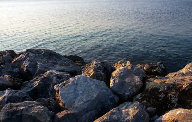 Calm seawater opposite rocks at a seaside village in northern Greece