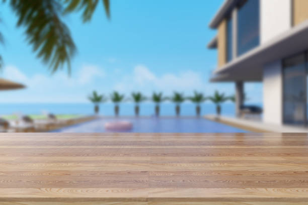 istock Empty Desk And Holiday Villa With Swimming Pool as Background 1337804114