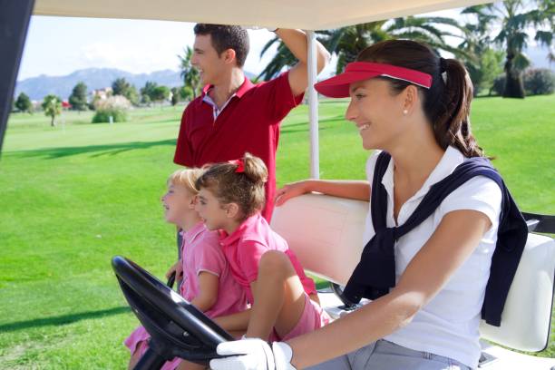 golf course family father mother daughters buggy - golf four people young adult playing imagens e fotografias de stock