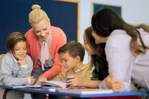 istock Children with teacher looking at tablet 1337805500