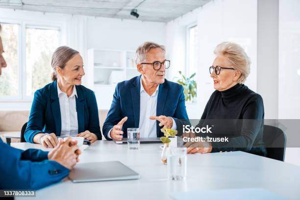 Senior Business People During Meeting Stock Photo - Download Image Now - Shareholder, Agreement, Senior Men