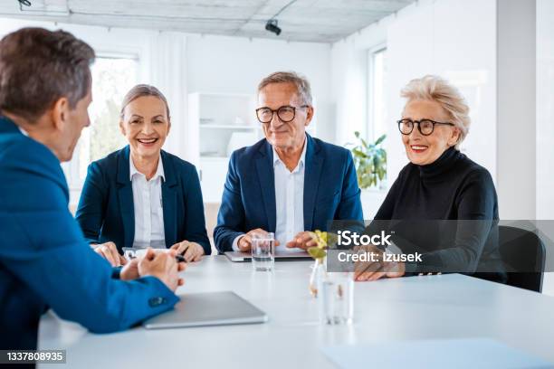 Senior Business People During Meeting Stock Photo - Download Image Now - Charitable Foundation, Meeting, Non-Profit Organization
