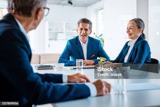 Senior Business People During Meeting Stock Photo - Download Image Now - Senior Women, Smiling, Three People