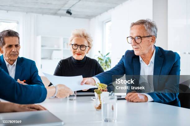 Senior Business People During Meeting Stock Photo - Download Image Now - Business, Exchanging, Females