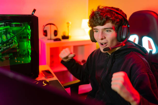 istock Excited gamer celebrating victory near computer 1337809398