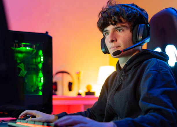 istock Teenager playing video game on computer 1337811350