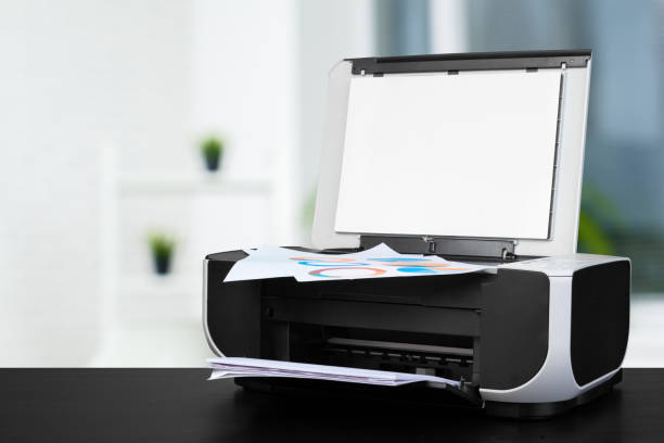 istock Compact laser printer on black desk against blurred background 1337812034