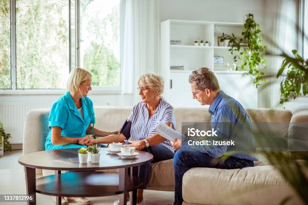 Elderly Lady Talking With Nurse Stock Photo - Download Image Now - Emotional Stress, Good News, Measuring