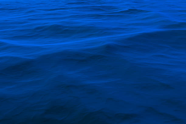 istock Background of a blue water surface with waves 1337812326