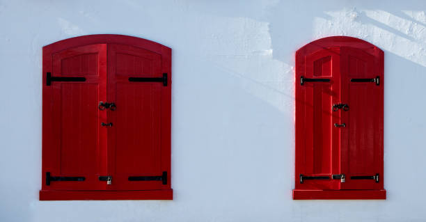 istock Red Window Shutters on a White Coastal Building 1337815303