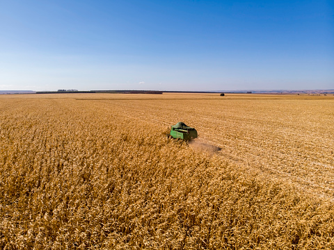 Photo taken with drone of a combine harvester working.