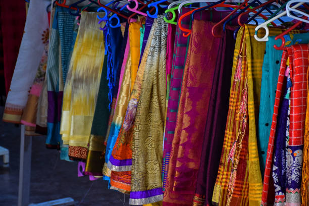 Stock photo of Beautiful colorful Indian saree hung on hanger in the display of saree shop at Kolhapur Maharashtra India. Stock photo of Beautiful colorful Indian saree hung on hanger in the display of saree shop at Kolhapur Maharashtra India. kolhapur stock pictures, royalty-free photos & images