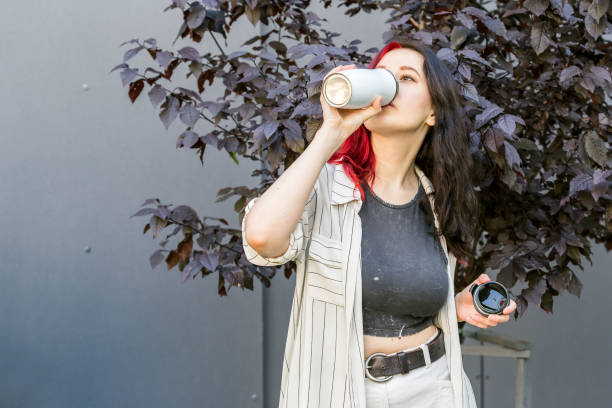 istock Woman holding a white reusable insulated mug 1337821803