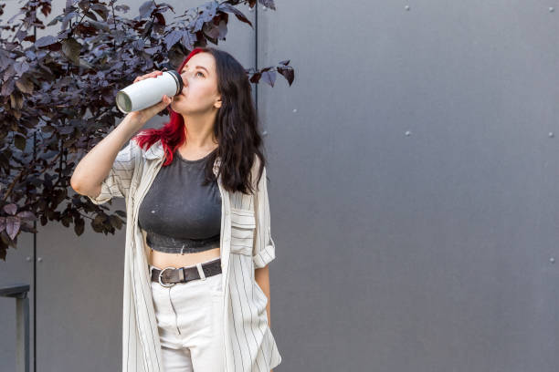 istock Woman holding a white reusable insulated mug 1337821815