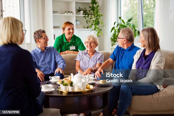 Cheerful Senior People In Retirement House Stock Photo - Download Image Now - Nursing Home, Sitting, Assisted Living