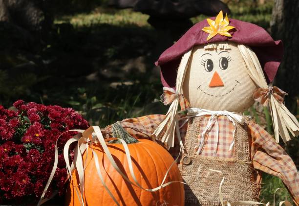 istock Scarecrow, Pumpkin and Fall Flowers 1337822280