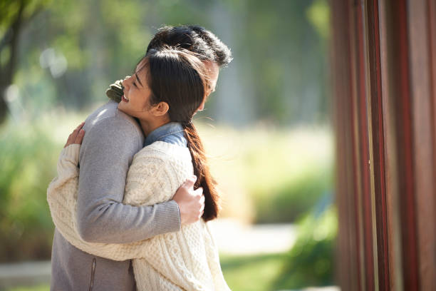 istock young asian couple hugging outdoors in park 1337822799