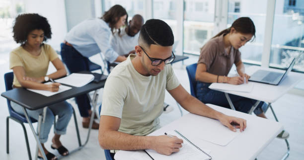 istock Shot of a classroom of students writing notes at university 1337824629