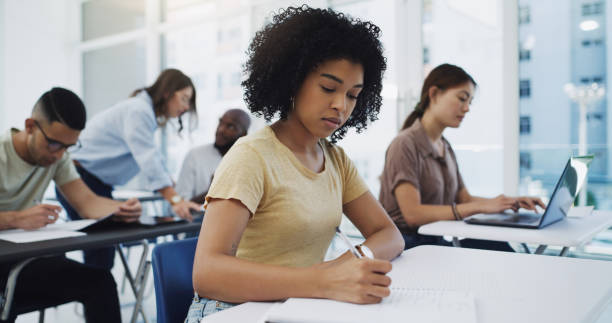 istock Shot of a classroom of students writing notes at university 1337824633