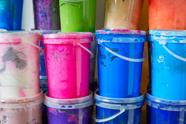 Colorful ink paint bottles in a row stacked