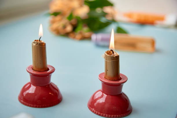 istock Golden candles on red candlestick, home coziness 1337833498