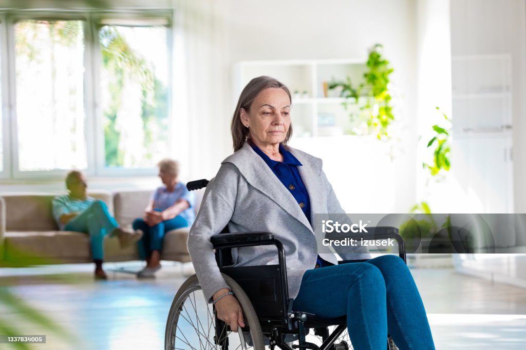 Elderly lady in wheelchair Elderly lady sitting in wheelchair. Worried senior woman in retirement house. 70-79 Years Stock Photo