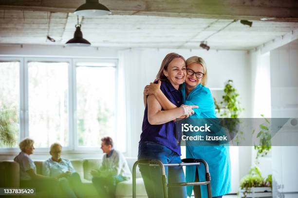 Nurse Helping Senior Woman To Use Walking Frame Stock Photo - Download Image Now - 70-79 Years, A Helping Hand, Adult