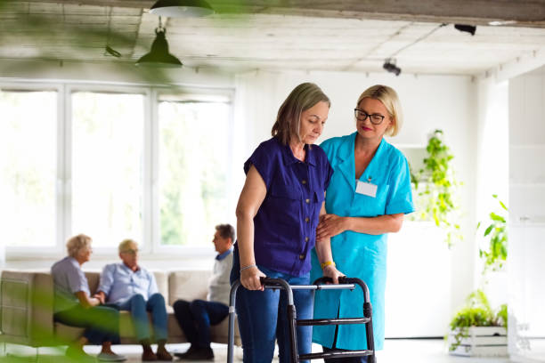 istock Nurse helping senior woman to use walking frame 1337835521