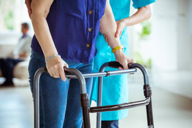istock Nurse helping senior woman to use walking frame 1337835835