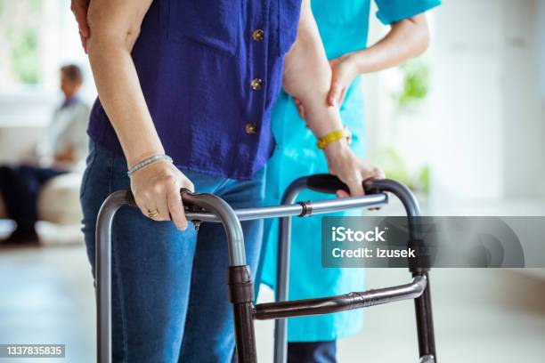 Nurse Helping Senior Woman To Use Walking Frame Stock Photo - Download Image Now - Parkinson's Disease, Patient, 70-79 Years