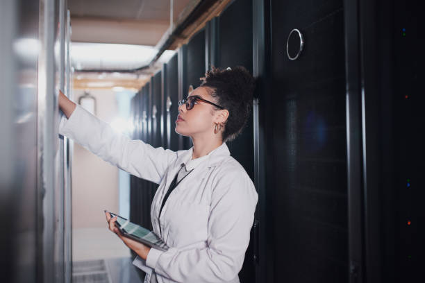 istock Shot of a young woman using a digital tablet in a server room at work 1337837859