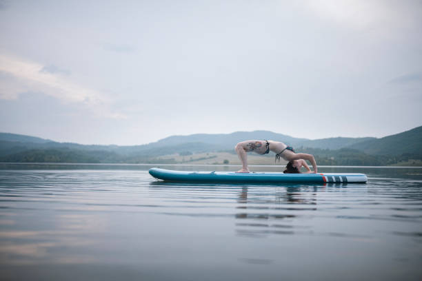 istock Young Woman Doing Yoga On Paddleboard 1337838823