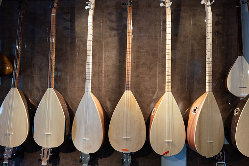 Group of Baglama, Saz, Middle Eastern and Anatolian Instrument hanging on the wall.