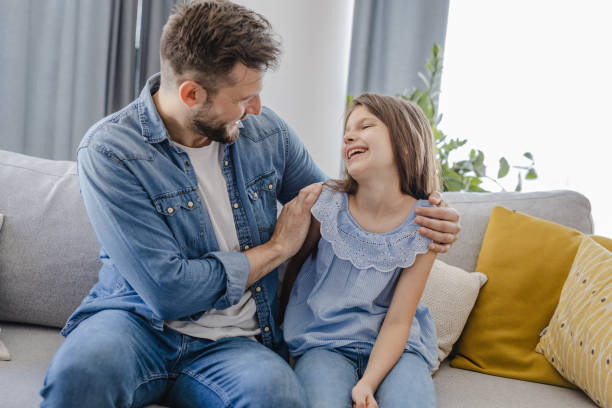 istock Father and daughter at home on the couch 1337841346