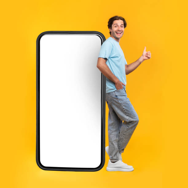 istock Man showing white empty smartphone screen and ok sign 1337841405
